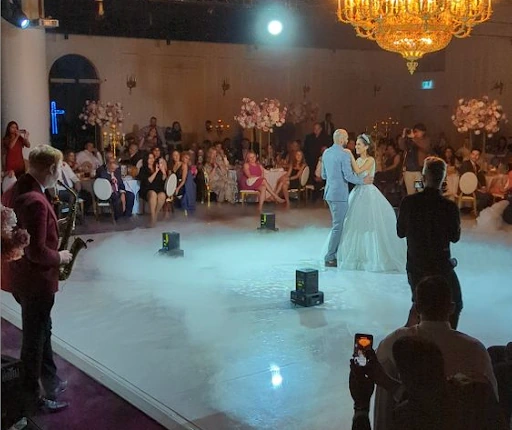 A recently married couple dancing on a stage.