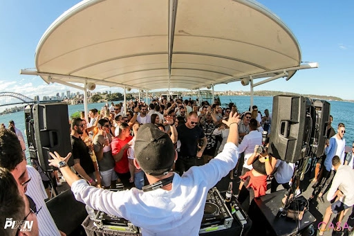 An image of boat party with subwoofers playing.