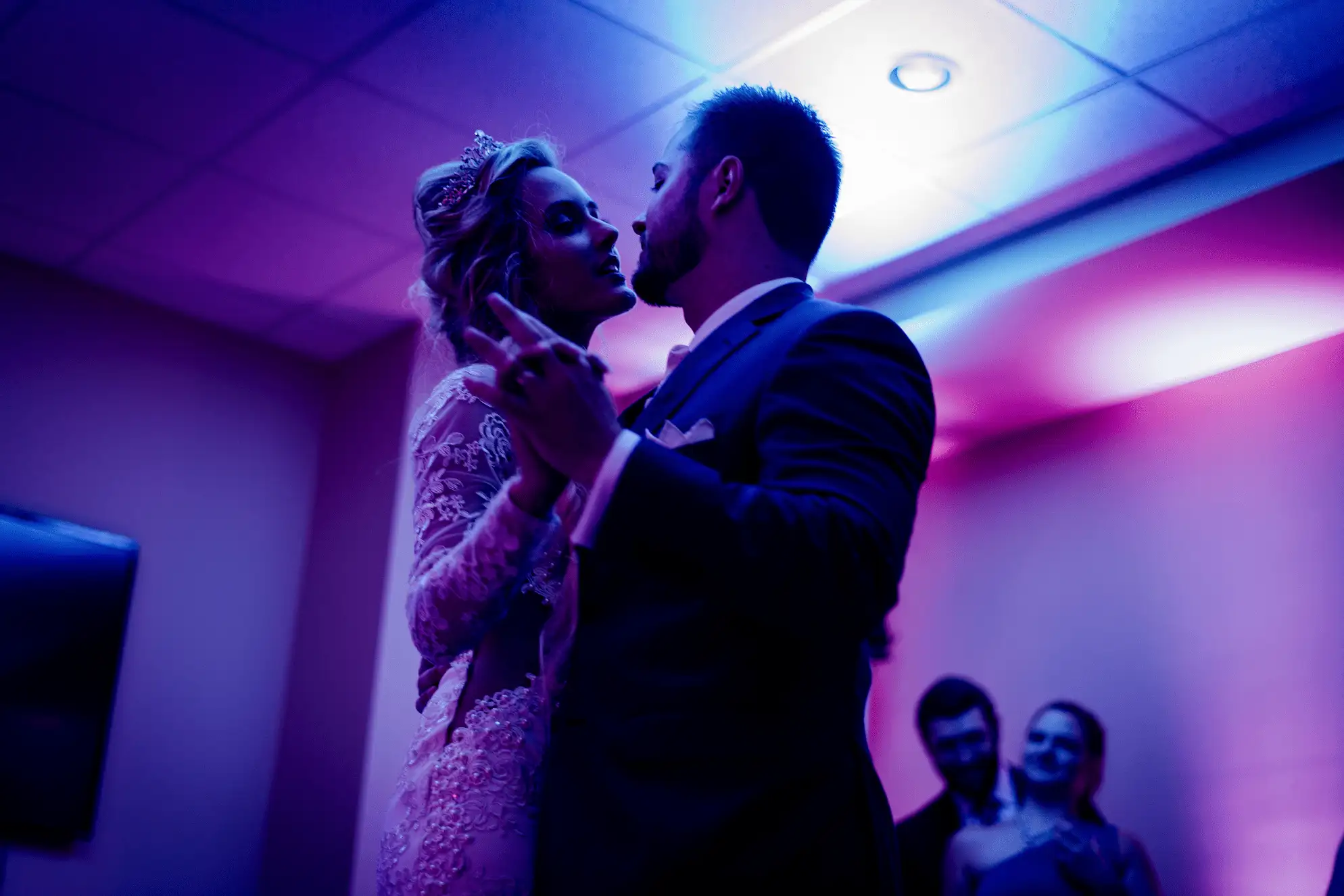 A couple dancing at a wedding with uplighting